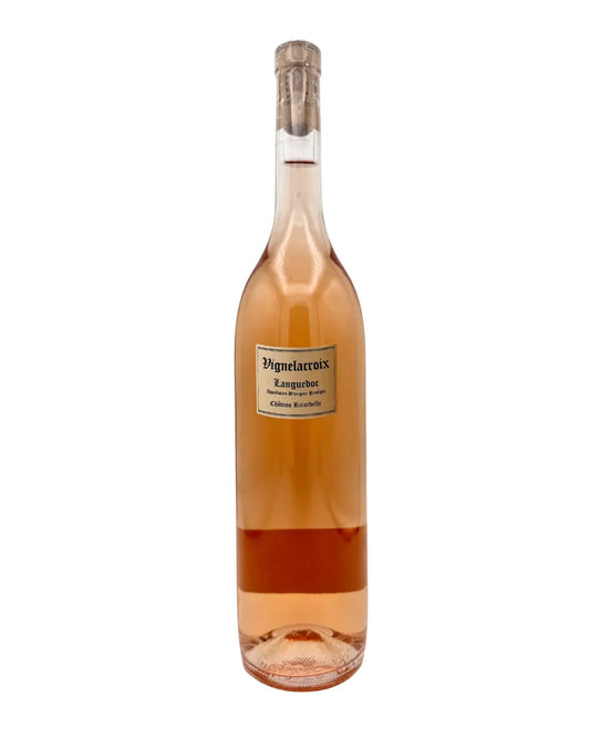 Bottle of Vignelacroix Languedoc Rosé from France, made using the saignée method, showing a bright pink colour in a clear glass bottle.